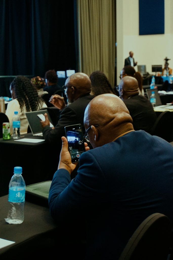 pexels-photo-33411205-33411205 Attendees at a business conference capturing moments on phones for notes and sharing.